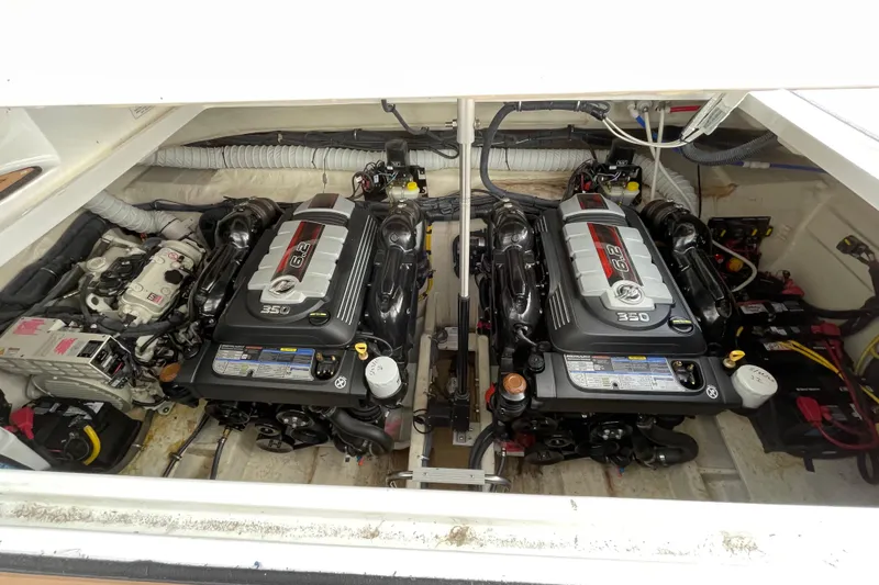 Slide: The Image of 2019 Rinker 370 EX cabin interior with cozy bed and striped bedding. - 24