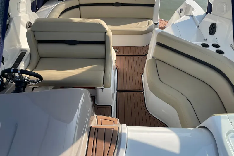 Slide: The Image of 2019 Rinker 370 EX boat on stands, surrounded by other vessels, under a partly cloudy sky. - 5