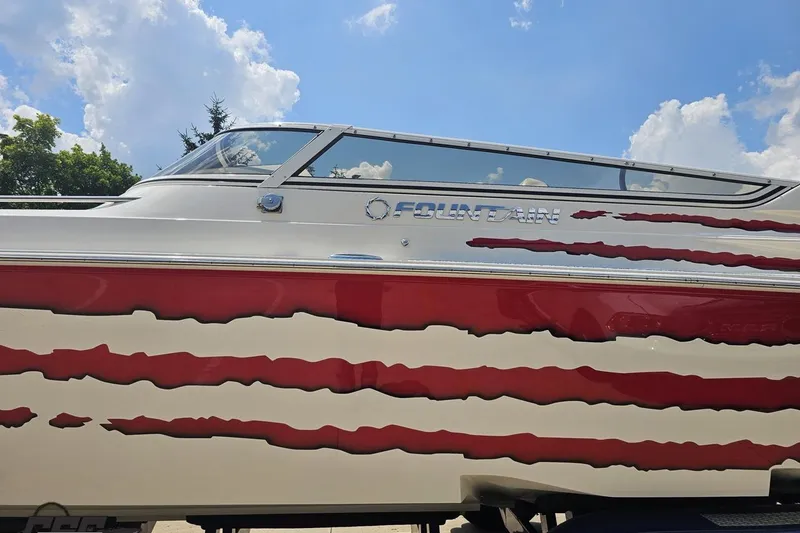 Slide: The Image of 2007 Fountain 42 Lightning boat with red and white design under a blue sky. - 18