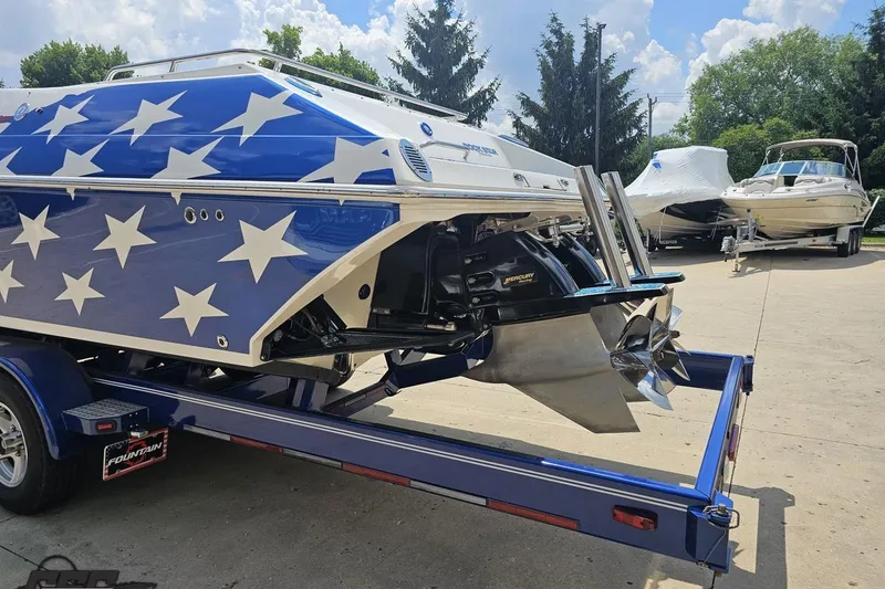 Slide: The Image of 2007 Fountain 42 Lightning boat with star design on trailer, featuring powerful Mercury engine. - 25