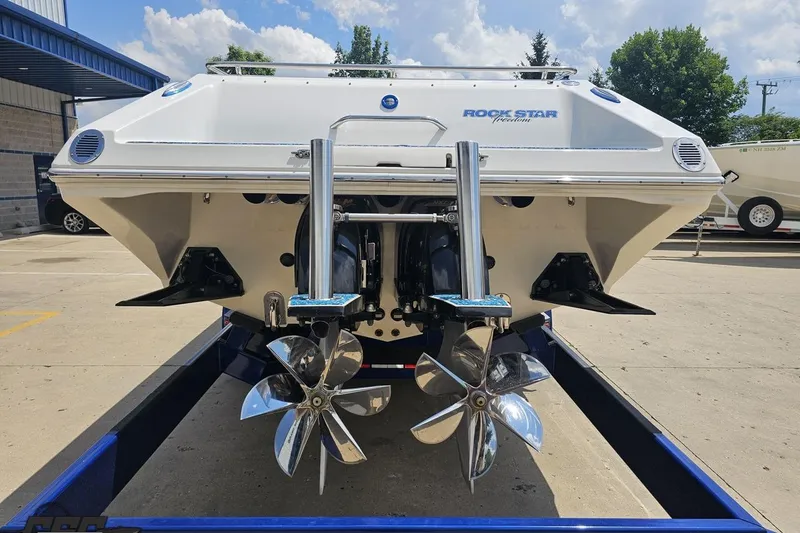 Slide: The Image of 2007 Fountain 42 Lightning boat with dual propellers on a trailer, under a blue sky. - 32