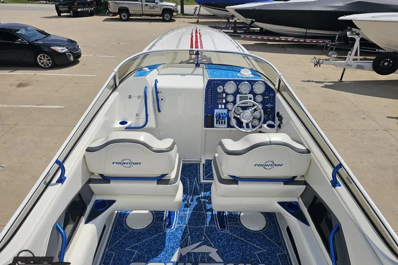 Slide: The Image of 2007 Fountain 42 Lightning boat interior with blue accents and modern dashboard controls. - 41