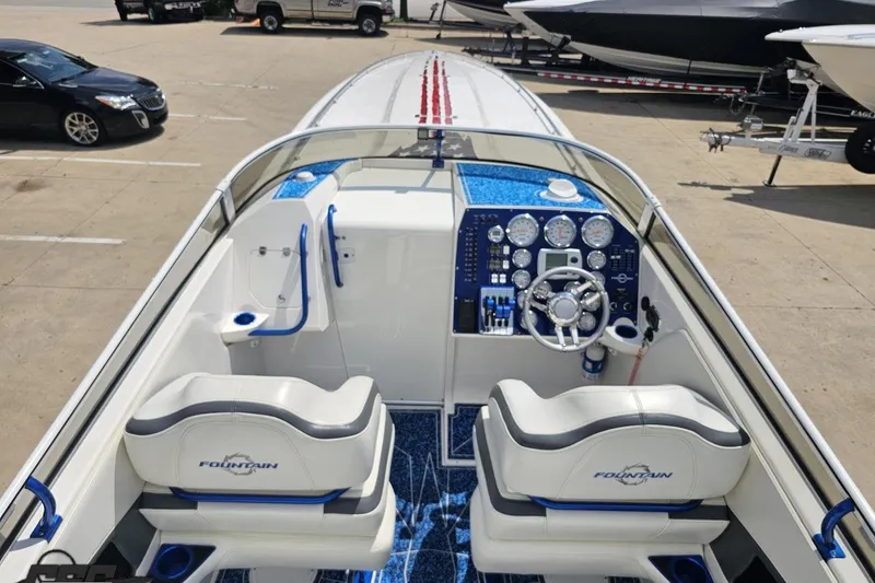 Slide: The Image of 2007 Fountain 42 Lightning boat interior with blue accents and modern dashboard controls. - 42