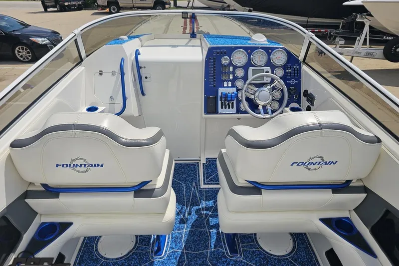 Slide: The Image of Interior of a 2007 Fountain 42 Lightning boat with white and blue seating. - 44