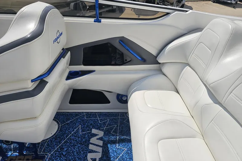 Slide: The Image of 2007 Fountain 42 Lightning boat interior with white leather seats and blue accents. - 46