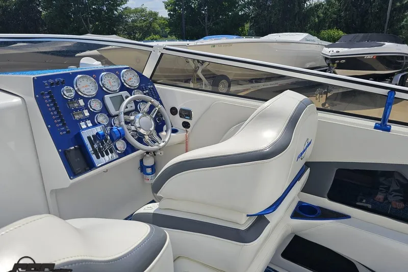Slide: The Image of 2007 Fountain 42 Lightning boat cockpit with gauges, steering wheel, and white seating. - 47