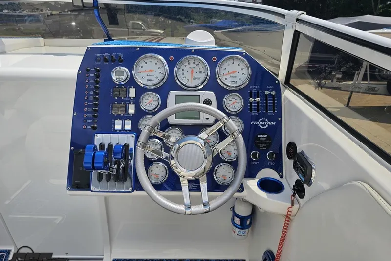 Slide: The Image of 2007 Fountain 42 Lightning boat dashboard with gauges and steering wheel. - 48