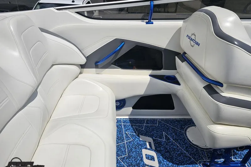 Slide: The Image of Interior of a 2007 Fountain 42 Lightning boat with white leather seating and blue accents. - 49