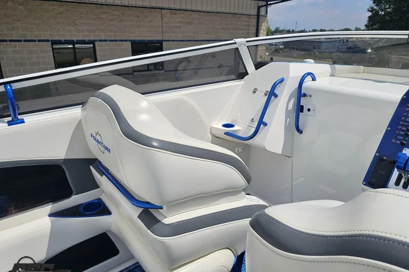 Slide: The Image of 2007 Fountain 42 Lightning boat interior with white and blue seating and dashboard. - 50