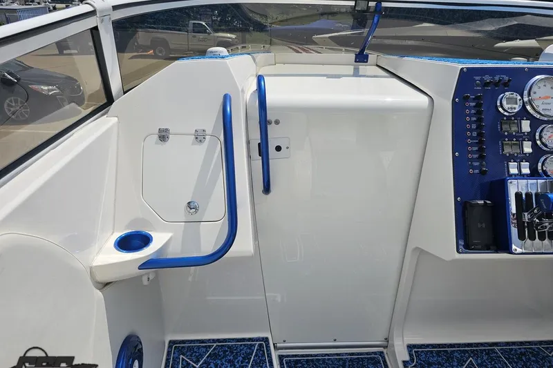 Slide: The Image of 2007 Fountain 42 Lightning boat cockpit with blue accents and control panel. - 51