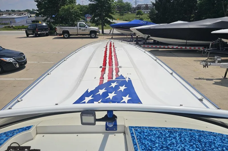 Slide: The Image of 2007 Fountain 42 Lightning boat with American flag design on deck, parked in a lot. - 62