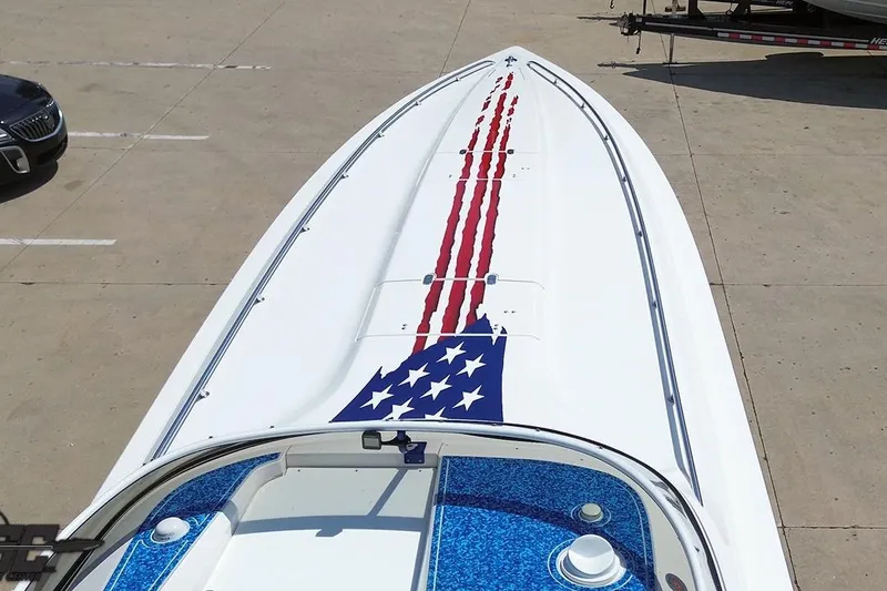 Slide: The Image of 2007 Fountain 42 Lightning boat with American flag design on deck, parked on concrete. - 63