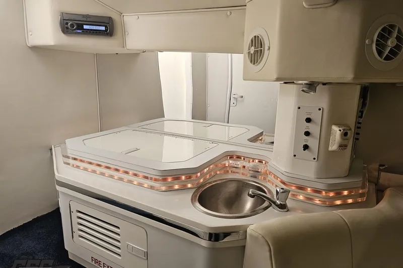 Slide: The Image of 2007 Fountain 42 Lightning boat interior with kitchenette, sink, and ambient lighting. - 71