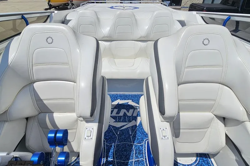 Slide: The Image of 2007 Fountain 42 Lightning boat interior with white leather seats and blue accents. - 80
