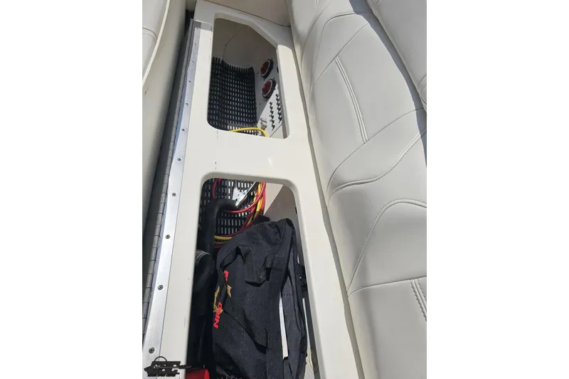 Slide: The Image of 2007 Fountain 42 Lightning boat interior with white seating and storage compartment. - 88