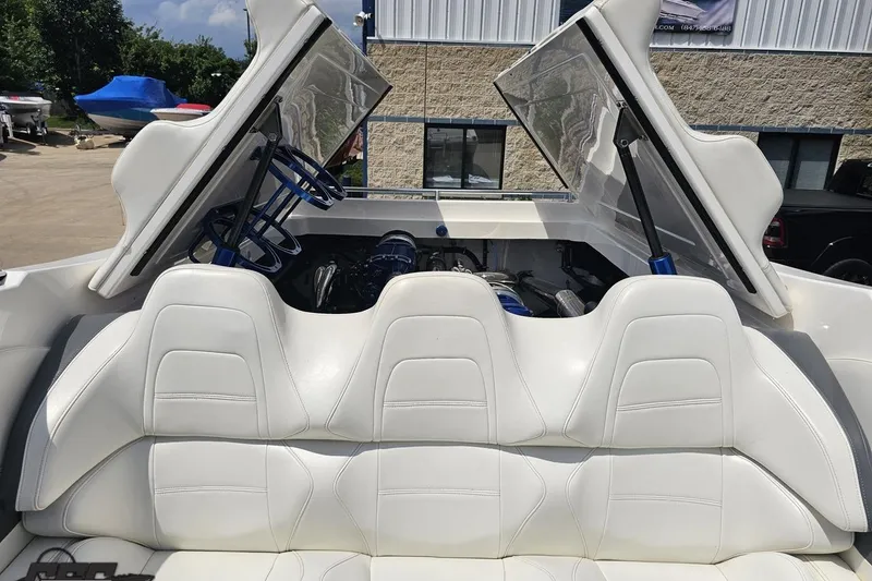 Slide: The Image of 2007 Fountain 42 Lightning boat interior with white seating and open engine compartment. - 90
