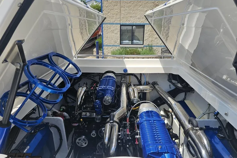 Slide: The Image of Engine compartment of a 2007 Fountain 42 Lightning boat with blue and chrome components. - 91