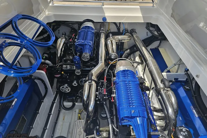 Slide: The Image of Engine compartment of a 2007 Fountain 42 Lightning boat, featuring blue and chrome components. - 93