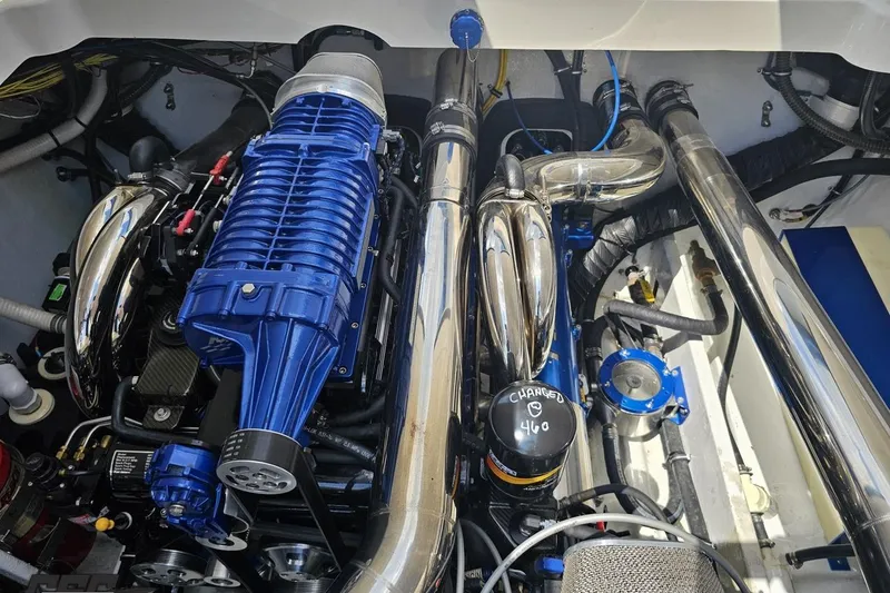 Slide: The Image of Engine compartment of a 2007 Fountain 42 Lightning boat, featuring a powerful blue supercharger. - 96
