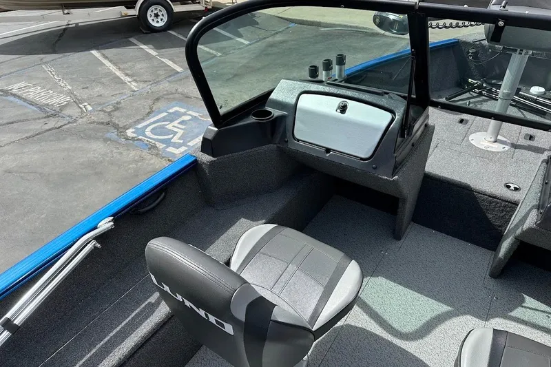 Slide: The Image of 2024 Lund 1650 Rebel XL Sport boat interior with seating and console. - 12