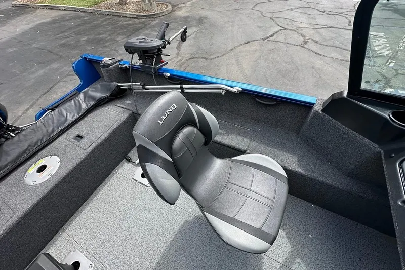 Slide: The Image of 2024 Lund 1650 Rebel XL Sport boat interior with a comfortable seat and fishing equipment. - 13