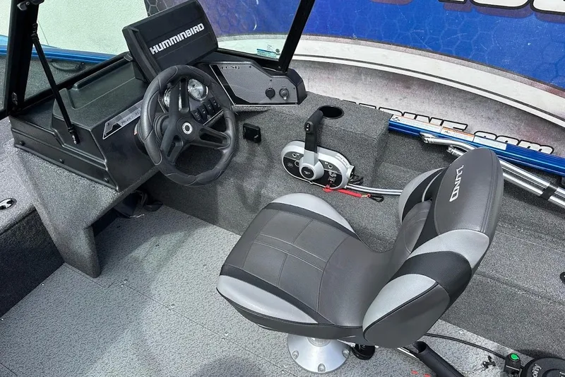 Slide: The Image of 2024 Lund 1650 Rebel XL Sport boat interior with steering wheel and seat. - 18