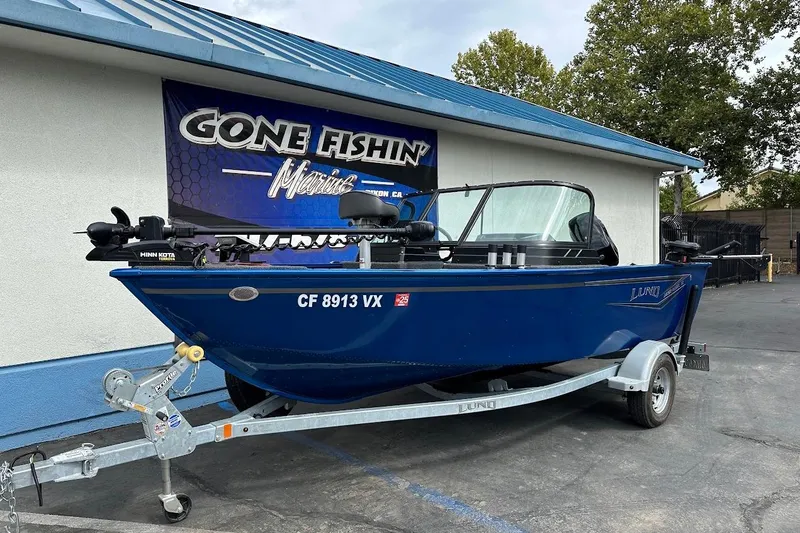Slide: The Image of 2024 Lund 1650 Rebel XL Sport boat on trailer at Gone Fishin' Marine dealership. - 2