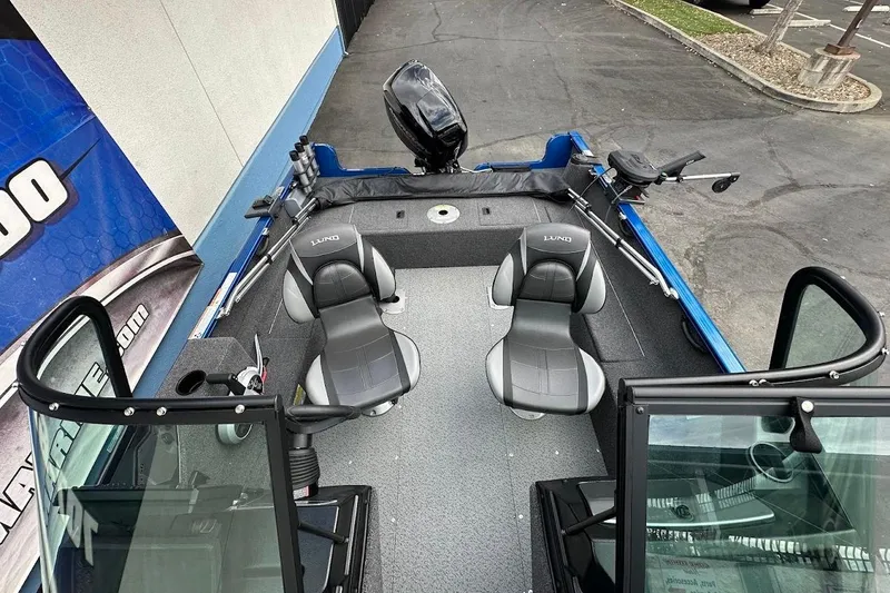 Slide: The Image of 2024 Lund 1650 Rebel XL Sport boat interior with seating and fishing equipment. - 29