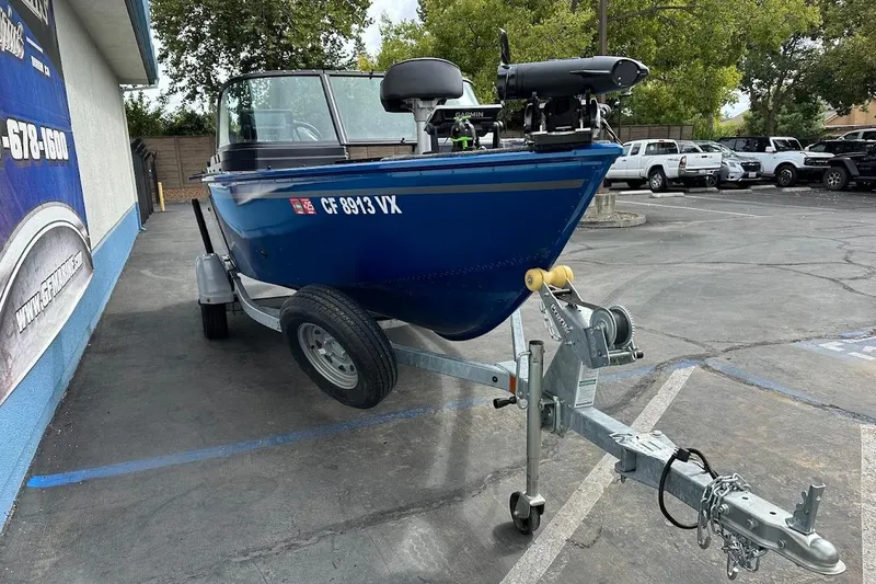 Slide: The Image of 2024 Lund 1650 Rebel XL Sport boat on trailer in parking lot. - 4