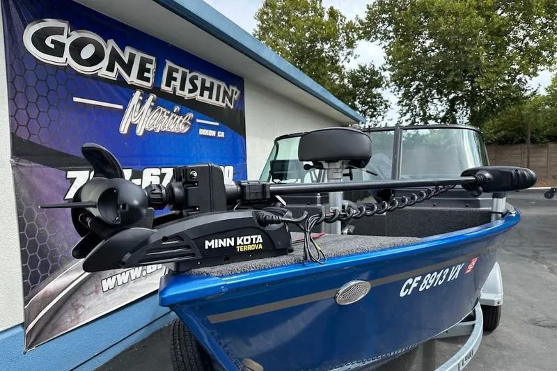 Slide: The Image of 2024 Lund 1650 Rebel XL Sport boat with Minn Kota Terrova motor at dealership. - 5