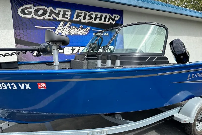 Slide: The Image of 2024 Lund 1650 Rebel XL Sport boat in blue, displayed at Gone Fishin' Marine. - 6