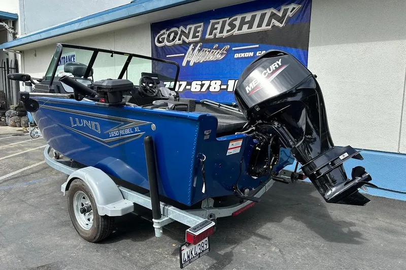 Slide: The Image of 2024 Lund 1650 Rebel XL Sport boat with Mercury engine on trailer. - 8