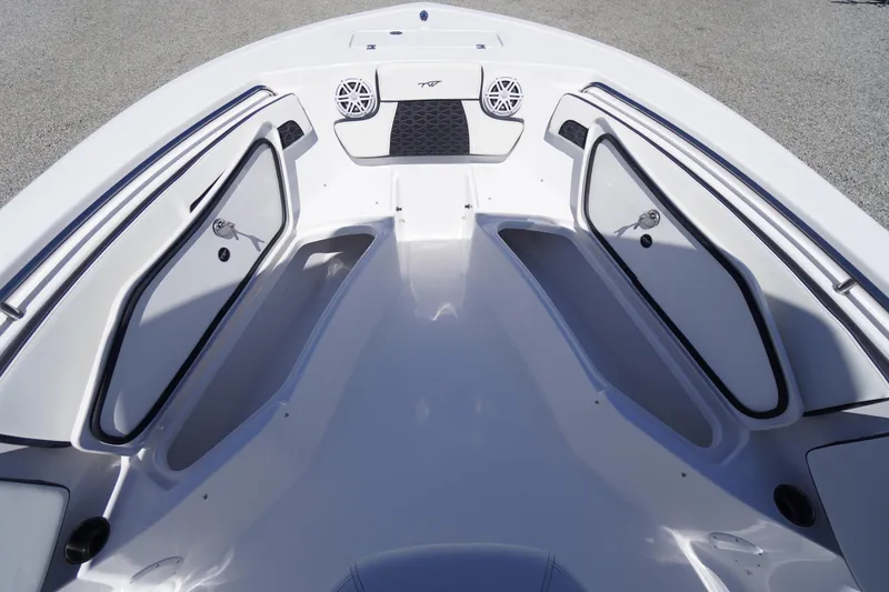 Slide: The Image of 2026 Tidewater 220 CC Adventure boat interior with storage compartments and speakers. - 11