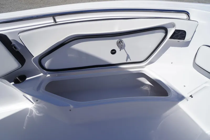 Slide: The Image of 2026 Tidewater 220 CC Adventure boat storage compartment with sleek design and secure lock. - 13