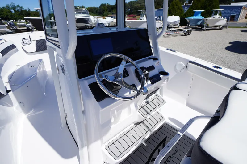 Slide: The Image of 2026 Tidewater 220 CC Adventure boat cockpit with modern steering and controls. - 19