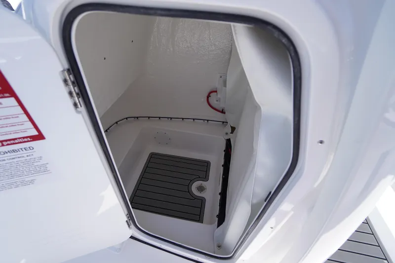 Slide: The Image of 2026 Tidewater 220 CC Adventure boat storage compartment interior. - 21