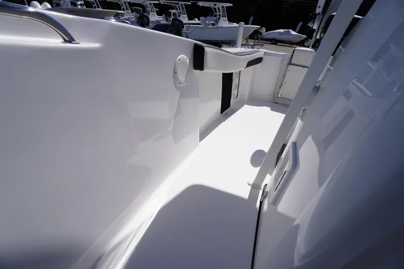 Slide: The Image of 2026 Tidewater 220 CC Adventure boat interior with sleek white deck and seating. - 28