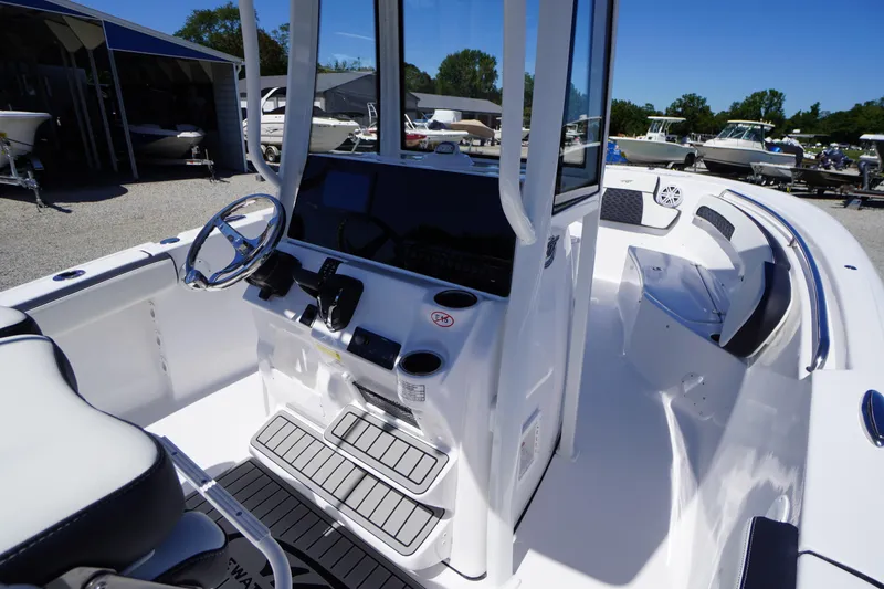 Slide: The Image of 2026 Tidewater 220 CC Adventure boat interior with steering console and seating. - 30