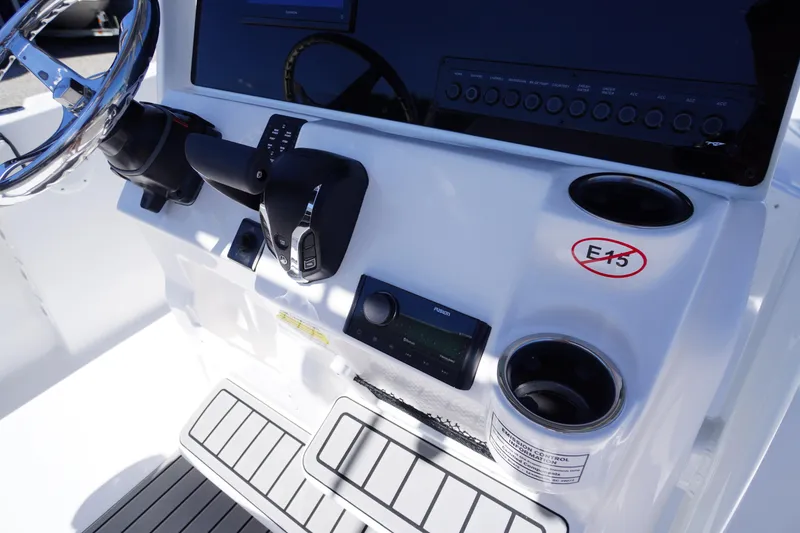 Slide: The Image of 2026 Tidewater 220 CC Adventure boat console with steering wheel and controls. - 32