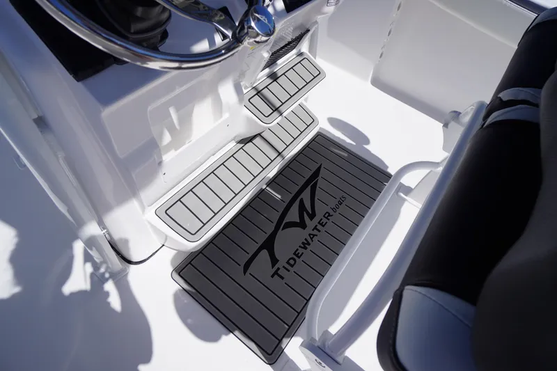 Slide: The Image of 2026 Tidewater 220 CC Adventure boat interior with branded floor mats. - 33