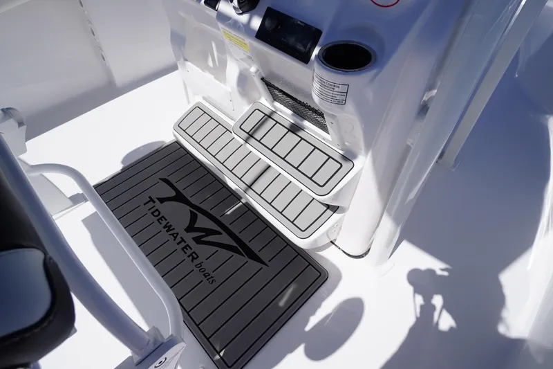 Slide: The Image of 2026 Tidewater 220 CC Adventure boat interior with branded mat and console details. - 34