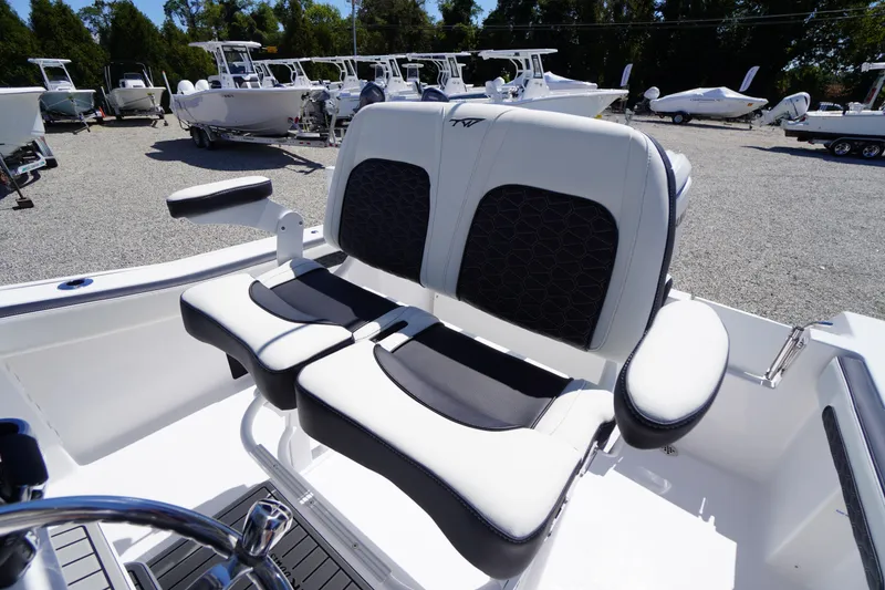Slide: The Image of 2026 Tidewater 220 CC Adventure boat seating in a sunny outdoor showroom. - 36