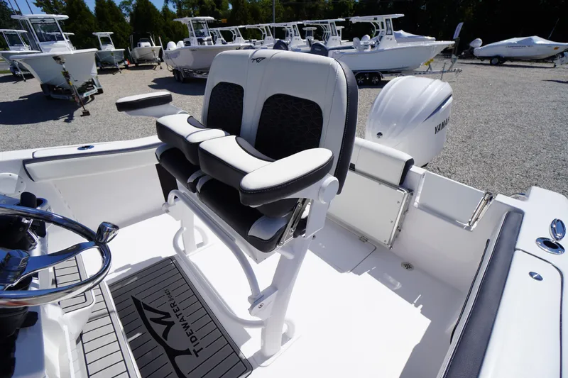 Slide: The Image of 2026 Tidewater 220 CC Adventure boat interior with seating and Yamaha engine. - 37
