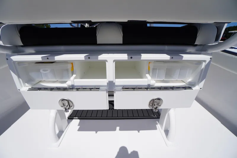 Slide: The Image of 2026 Tidewater 220 CC Adventure boat storage compartments with secure locks and organized interior. - 39