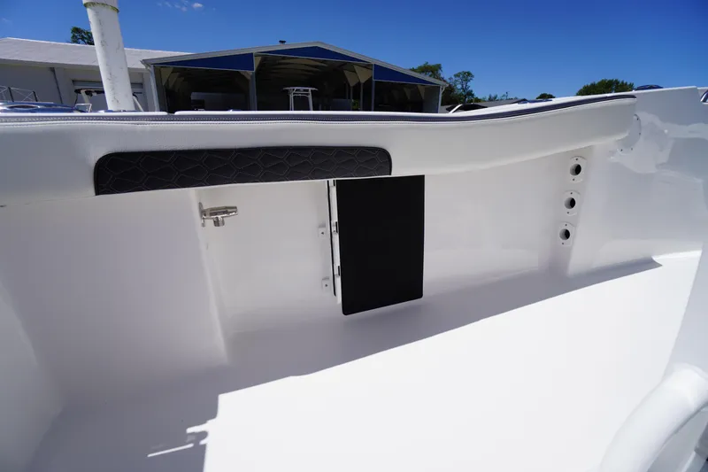 Slide: The Image of 2026 Tidewater 220 CC Adventure boat interior detail, featuring sleek white design and storage compartment. - 41