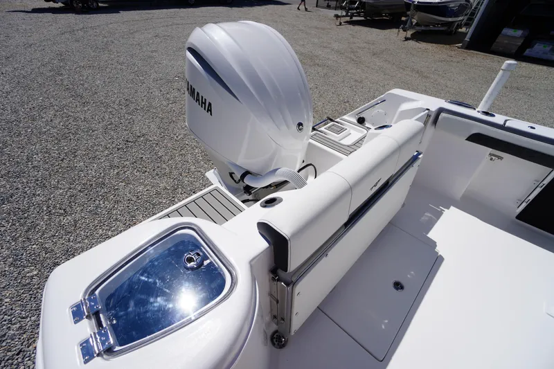 Slide: The Image of 2026 Tidewater 220 CC Adventure boat with Yamaha engine, rear seating, and storage compartment. - 44
