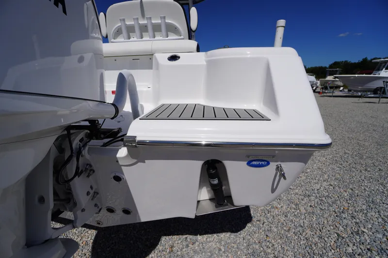 Slide: The Image of 2026 Tidewater 220 CC Adventure boat stern view with swim platform and seating. - 49