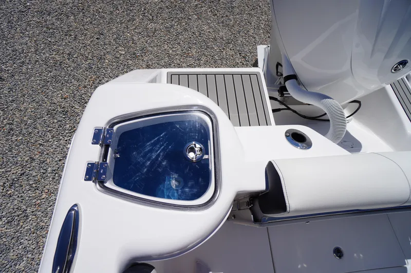 Slide: The Image of 2026 Tidewater 220 CC Adventure boat deck with storage compartment and seating. - 51