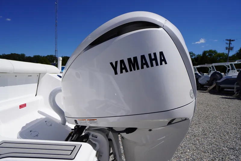 Slide: The Image of Yamaha outboard motor on 2026 Tidewater 220 CC Adventure boat, sunny day, gravel lot. - 53