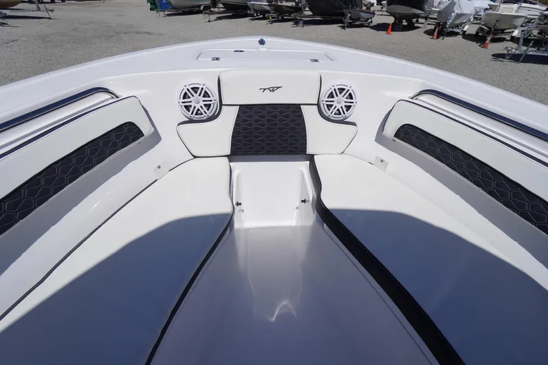 Slide: The Image of 2026 Tidewater 220 CC Adventure boat interior with cushioned seating and speakers. - 6